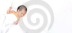 Cute newborn baby girl in white blanket onÂ nurseryÂ bed.Â AdorableÂ new born child, little boy eyes look people Family, new